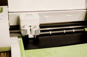 The Cricut machine cutting out the vinyl   